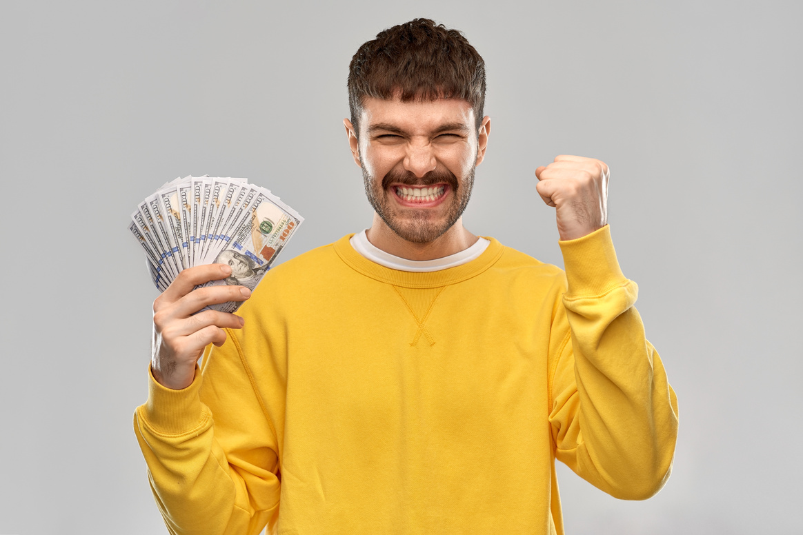 Happy Young Man with Money Celebrating Success