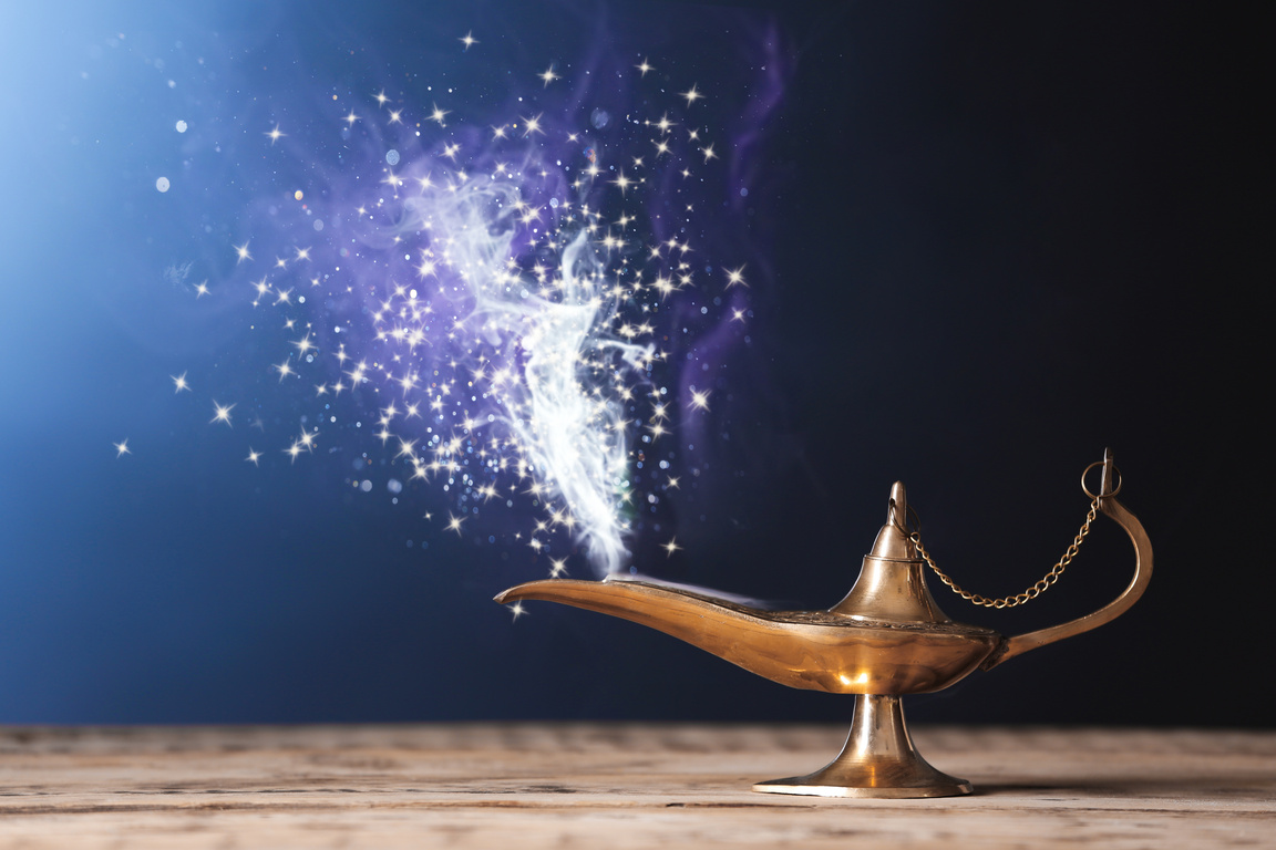 Lamp of Wishes on Wooden Table against Color Background